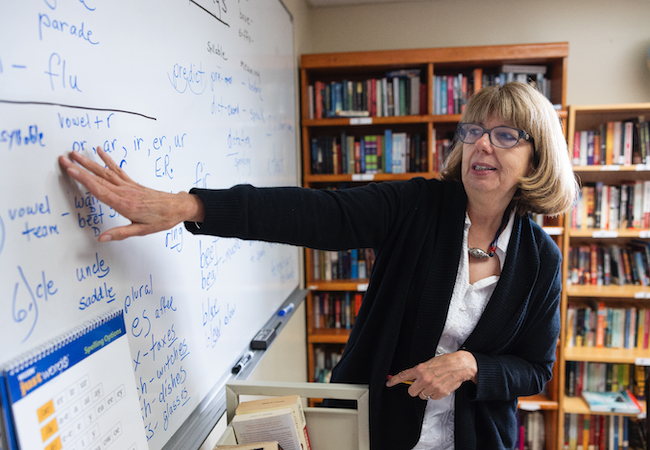 Jeanne Smith points to words on a white board during her reading lessons