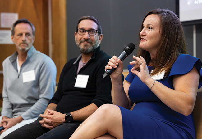 Lara Paparo seated alongside Thinkist executives Jared Wells and Mark Manasse, speaking into a microphone.