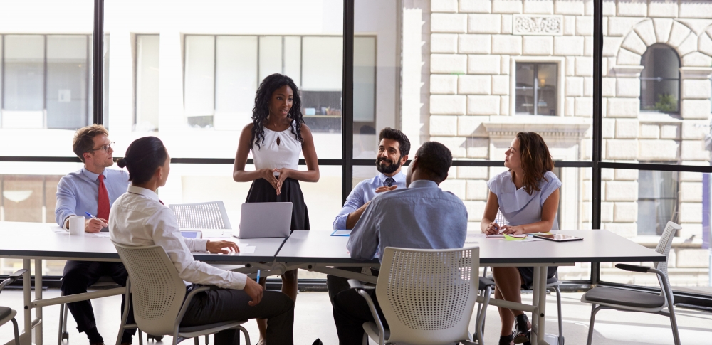 Executives working around a conference table.