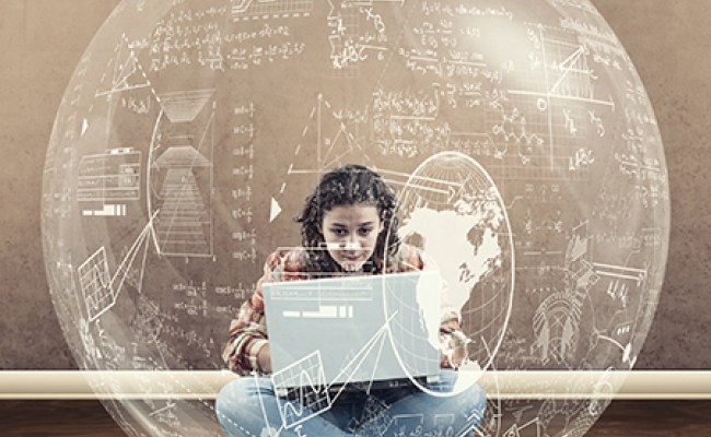 A young woman types on a laptop within a sphere of equations