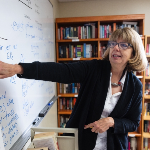 Jeanne Smith points to words on a white board during her reading lessons