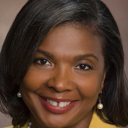 Smiling woman with pearl earrings