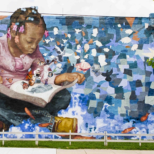 Painting of girl reading book with butterflies flying out.
