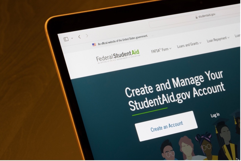 A laptop showing the website of Federal Student Aid